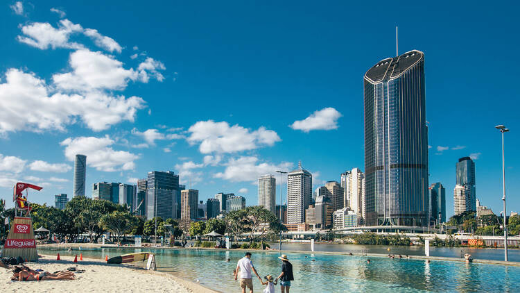 Brisbane skyline at golden hour with the river and South Bank Parklands, viewed from the west