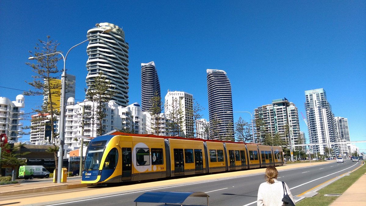 A G:link light rail tram at a Gold Coast station near the beach