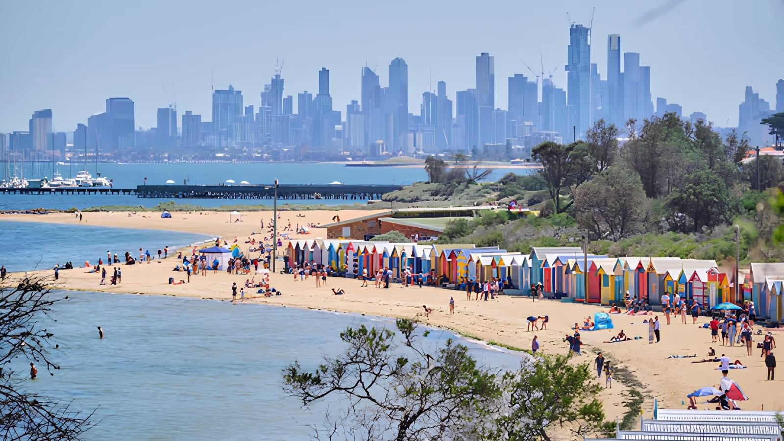 Sunset over St Kilda Beach and the pier in Melbourne, with the CBD skyline across Port Phillip Bay
